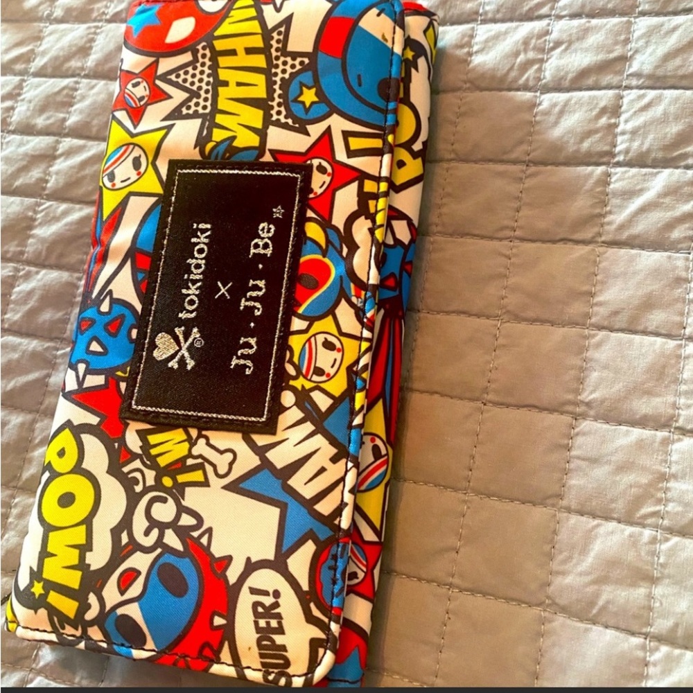 Brand new, tags attached JuJuBe wallet. Superhero theme.
